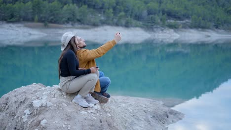 couple taking selfie by a lake