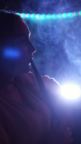 woman smoking hookah in a nightclub