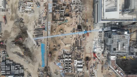 top down aerial of industrial construction site with two huge tower cranes