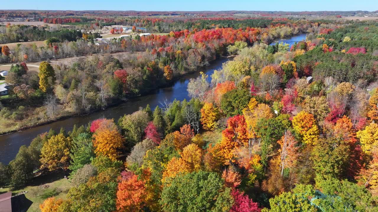 Beautiful Michigan river and fall colors captured from an aerial view moving forward panning slowly.