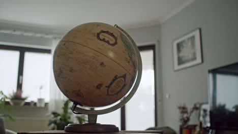 shot of a vintage globe spinning quickly in a modern living room