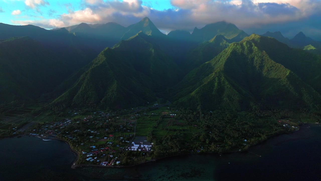 Teahupo'o surf wave lagoon Passe Havea coral reef harbor view Tahiti aerial drone French Polynesia South Pacific Ocean island last light on volcano peaks landscape beach coastline circle left motion
