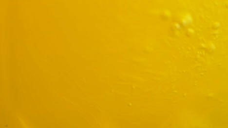 close-up of yellow liquid with bubbles