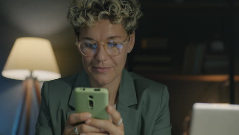 woman working late at night on her phone