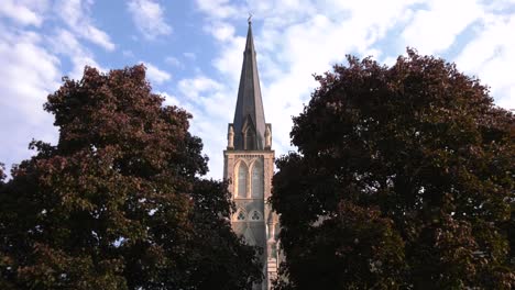 church steeple centred between trees