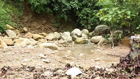 Flowing-Rainwater-in-Upper-Himalayas,-Uttarakhand-India-through-the-mountains,-making-natural-small-water-drains