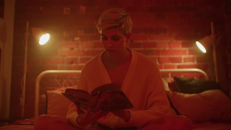 woman reading in a cozy bedroom at night