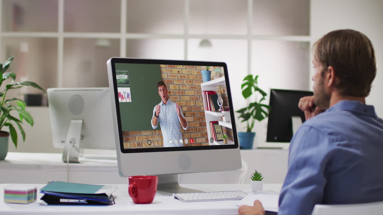 Caucasian male student using computer on video call with male teacher