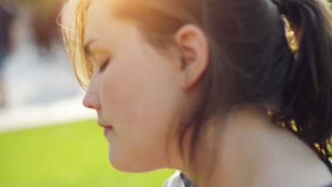 woman putting on suncreen outdoors