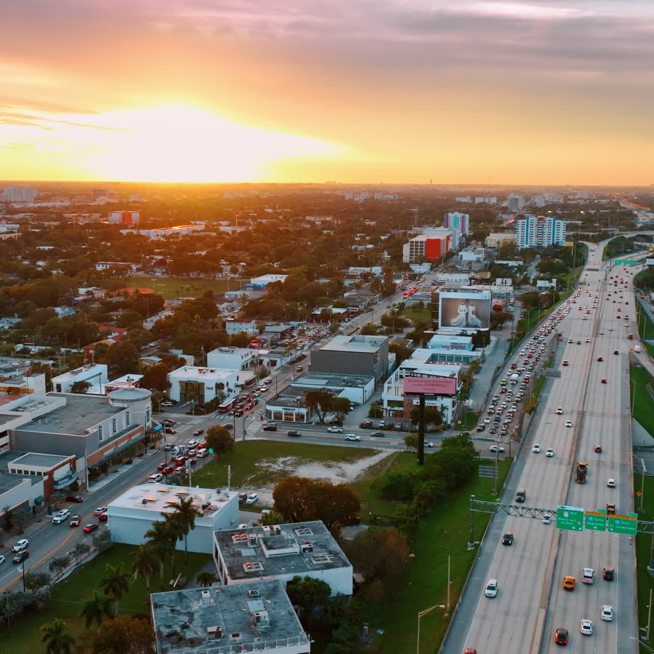Lively traffic on the roads on Miami, Florida, USA at sunset. Vibrant city scenery under the splendid colorful skies at sundown.