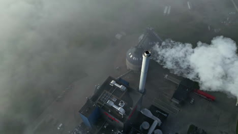 Aerial View of Factory with Smoke Stack on a Foggy Morning