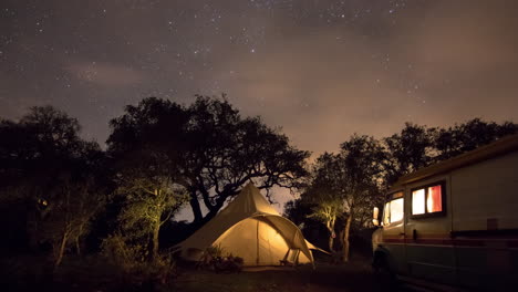 Dazzling-night-sky-sweeps-over-camp-site,-time-lapse