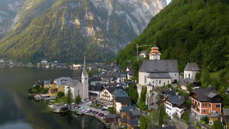 cinematic aerial view above hallstatt, austria during golden hour