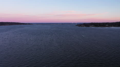 an aerial shot over a serene bay during a beautiful sunrise