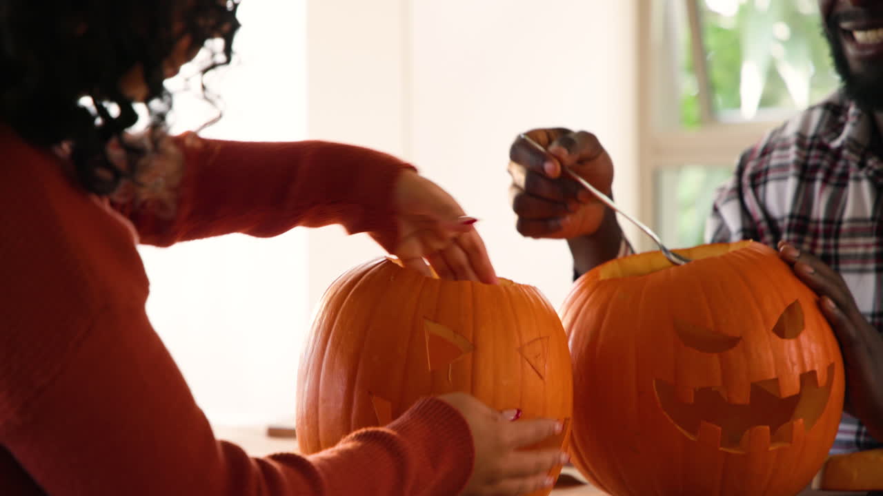 Halloween time, Carving pumpkins, creating festive Halloween decorations at home, hands in action