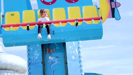 child on amusement park ride in brighton