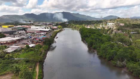 scenic river flowing through labasa town in northern fiji - aerial drone shot