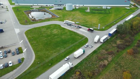 warehouses, huge logistics center near the highway, view of a large number of cargo trailers and containers, international cargo transportation, aerial view