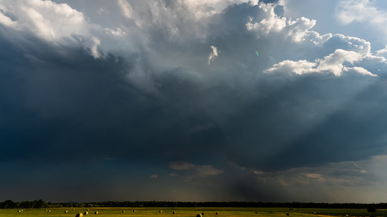 Building storm clouds over farmed fields time lapse
