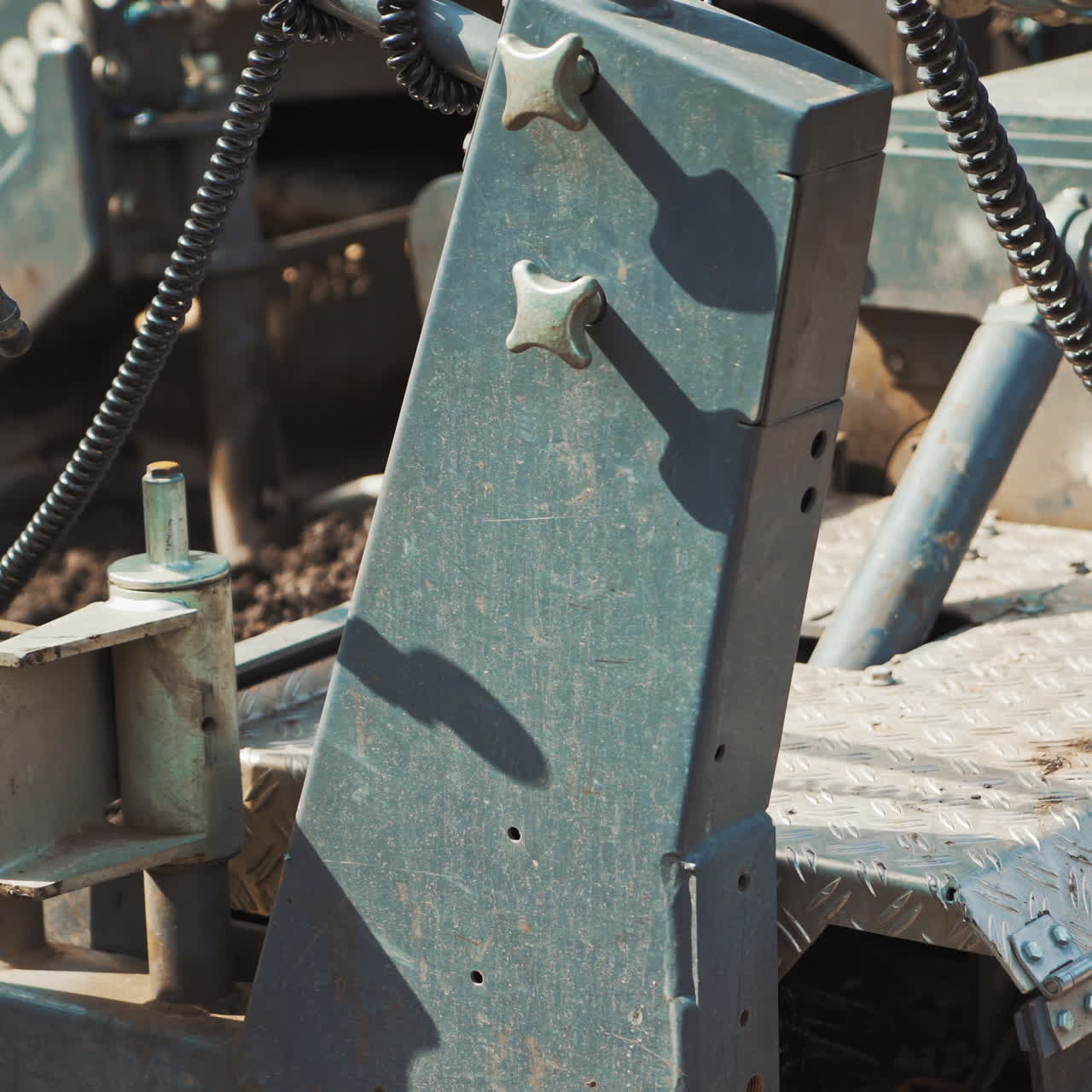Close-up of a heavy paver machine. Metatal construction of a big machine inside. Asphalt spreader at work. Large truck laying black bitumen.