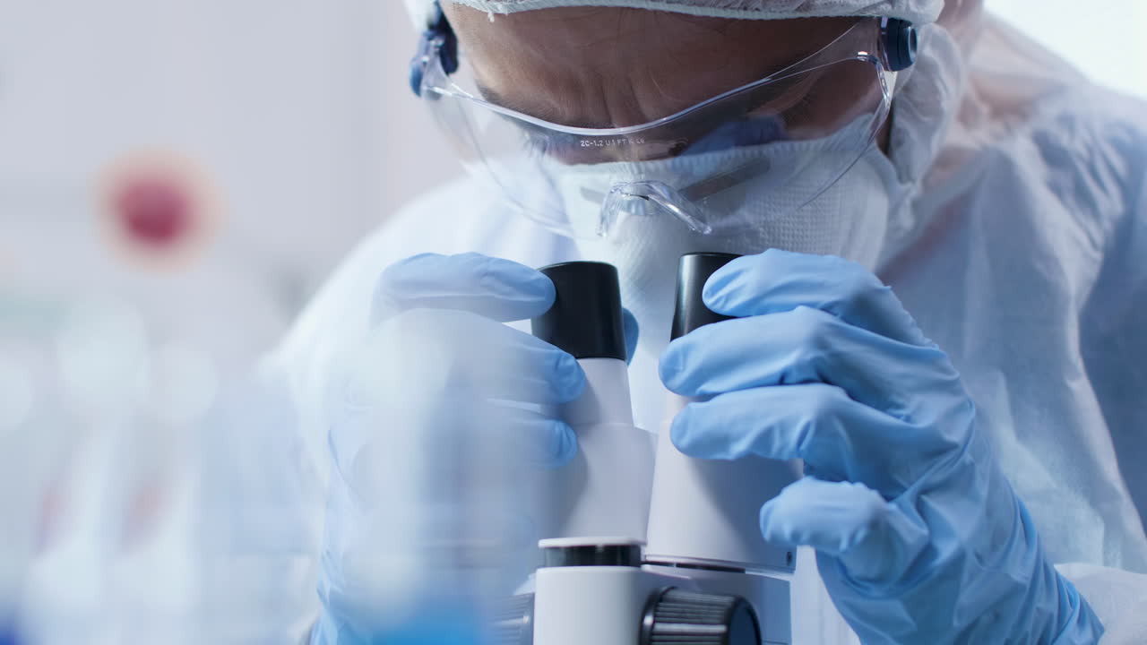 Scientist using microscope in lab