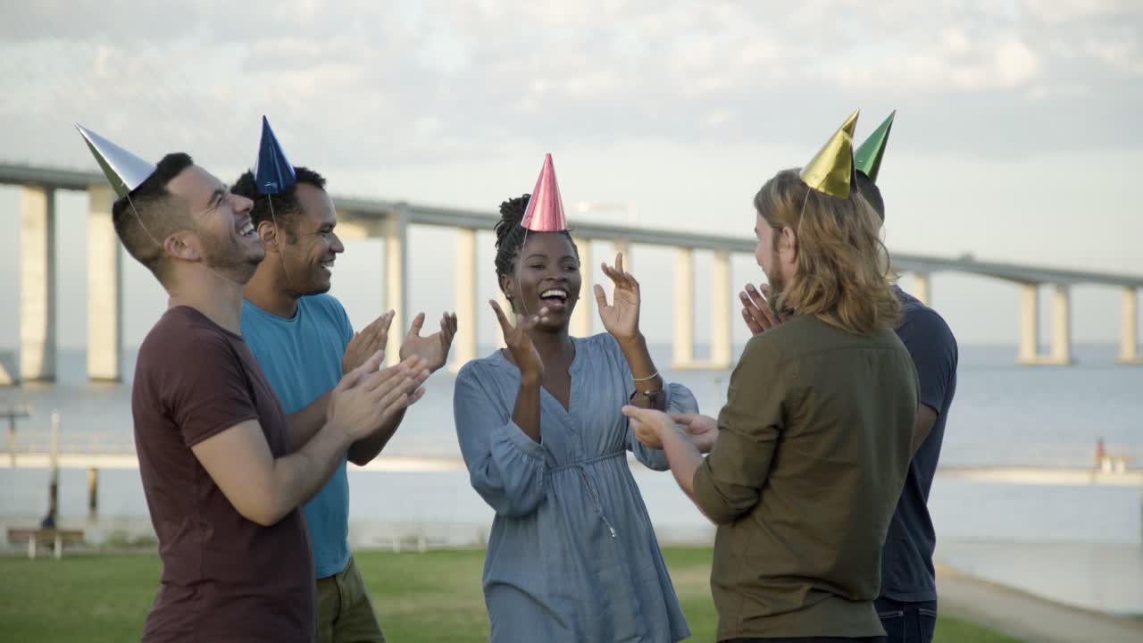 Funny friends celebrating birthday in paper hats
