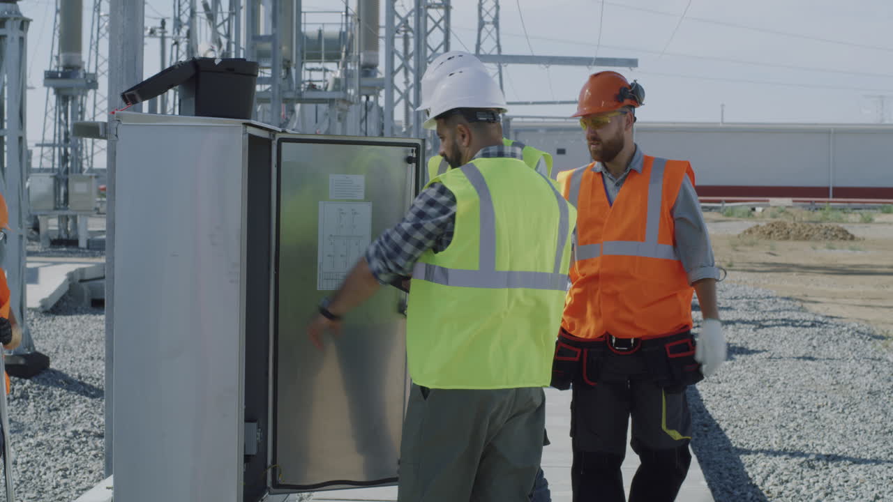 Electrical Engineers Inspecting Power Plant Equipment