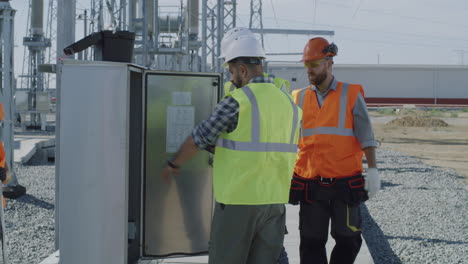 electrical engineers inspecting power plant equipment