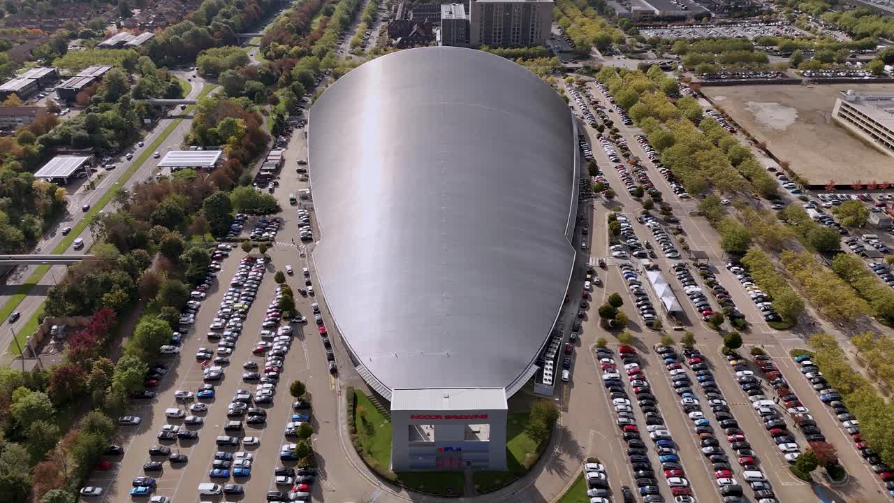 iFLY indoor skydiving centre aerial view overlooking aerodynamic silver shopping city and car park