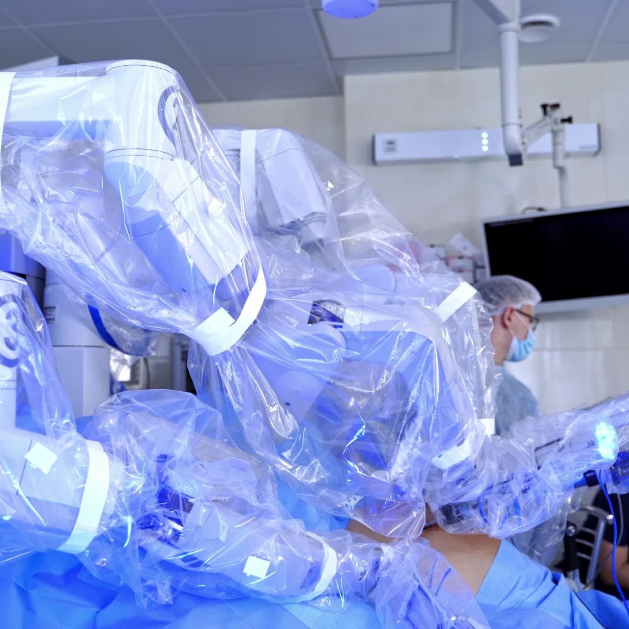 Work of robotic machine during surgery. New medical equipment in the operating room. Surgical arms of futuristic robot do minimally invasive operation.