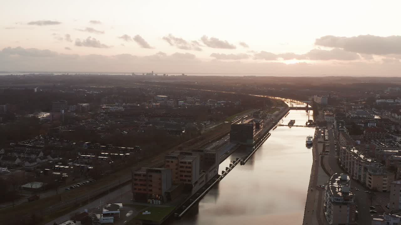 Drone shot of the Canal through Walcheren going through the city Middelburg, during sunset