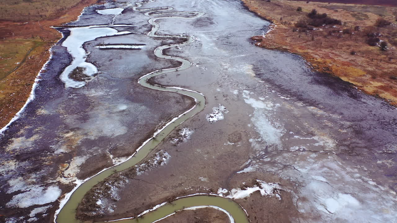 Natural problems of water. Dirty stream of dried lake. Gloomy background of environment. Global warming. Aerial view.