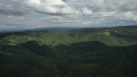 Area-Mountain-Range,-drone-view-of-green-plains,-carbon-footprint-and-climate-crisis,-nature-landscape,-forestry-and-agriculture