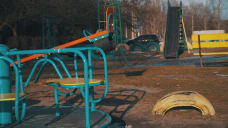 empty swing is spinning on the playground in the yard