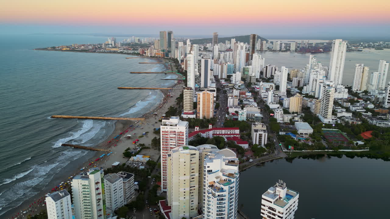 Aerial drone view of buildings alongside the Caribbean coastline in Cartagena, Colombia in the evening