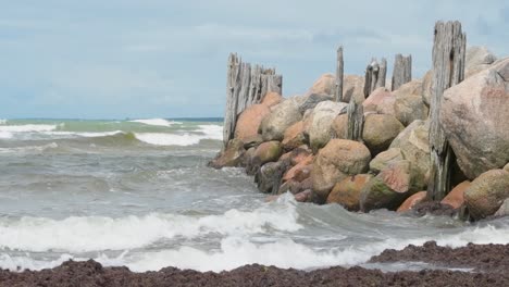 small sea waves splashing on breakwater