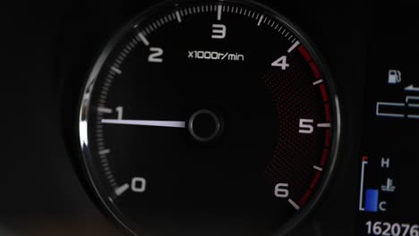 close up dashboard of car speedometer. the engine is accelerating. tachometer needle