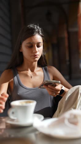 woman using phone in cafe