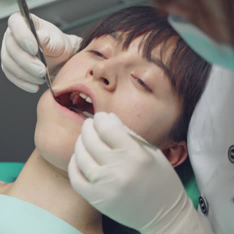 female dentist working in her dentist office. dental clinic. reception, examination of the patient.