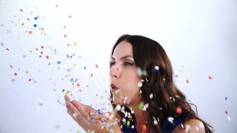 Smiling-woman-blowing-confetti-4k