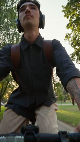 man riding a bicycle in a park