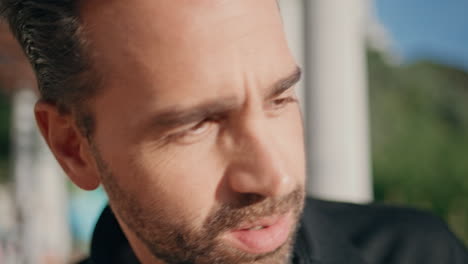 thoughtful man face looking distance at sunshine square closeup. guy thinking