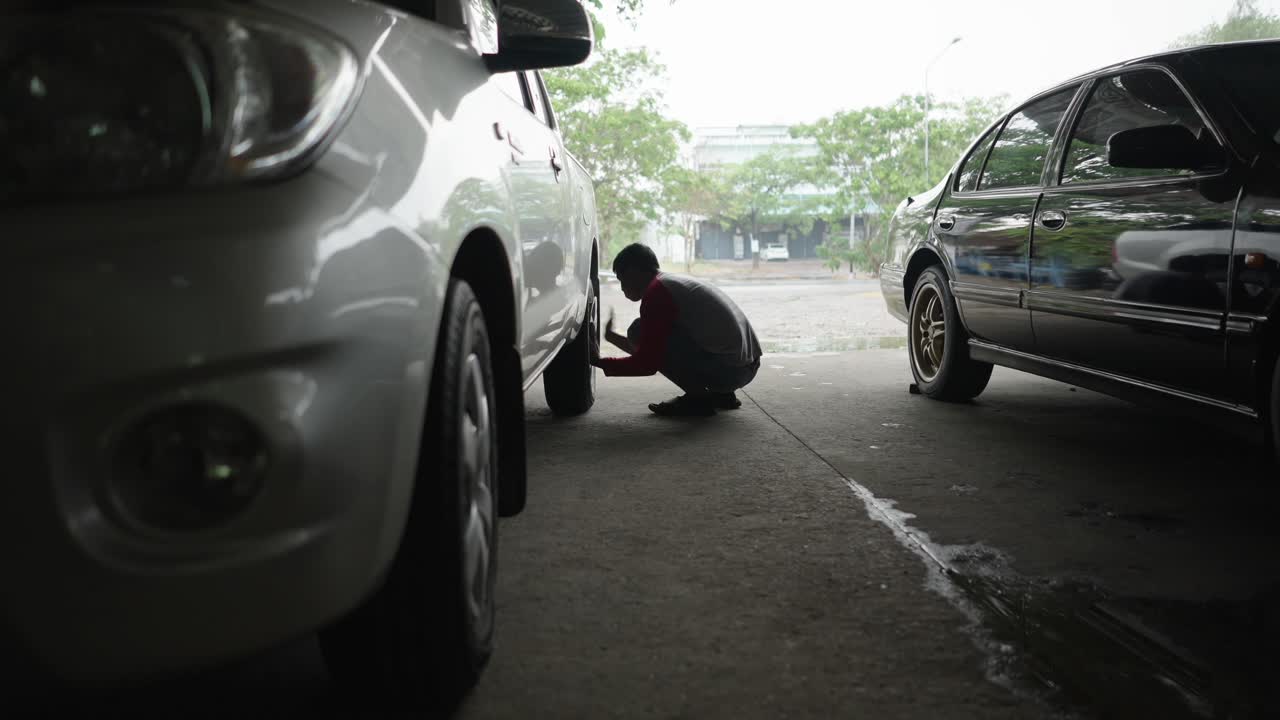 Man working on a car wheel
