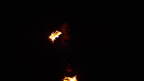 fire dancer making trails of fire in the dark