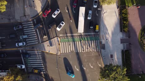 top-aerial-view-of-pedestrians-passing-safely-on-the-crosswalk-on-a-busy-avenue-in-buenos-aires-city