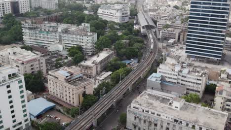 une photo aérienne évocatrice à bas angle montre un train de métro approchant de la station près du quartier des affaires