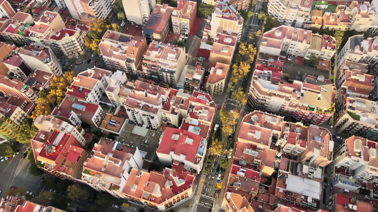 Aerial drone view of Barcelona, Spain. Blocks with multiple residential buildings, roads with cars