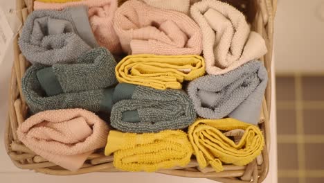 closeup of folded towels in a wicker basket