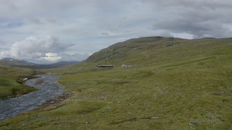 Base-camp-by-a-river-in-a-green-valley