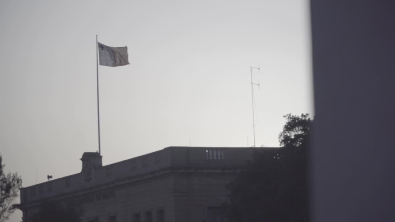 Pan a Maltese Flag in the distance